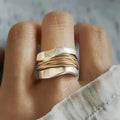 Elegant silver ring featuring delicate golden thread detailing